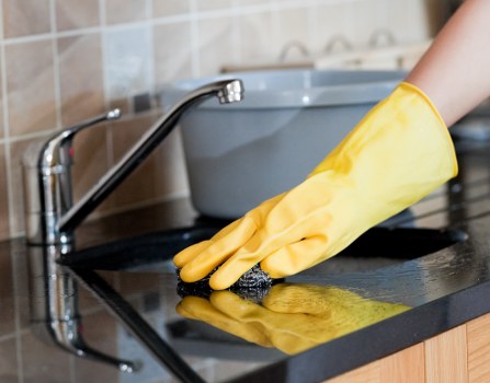 Cleaner working in a living room during a carpet service